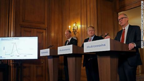 Boris Johnson, center, flanked by Chief Medical Officer for Britain, Chris Whitty, left, and Chief Scientific Adviser Patrick Vallance at a March 12 press conference.