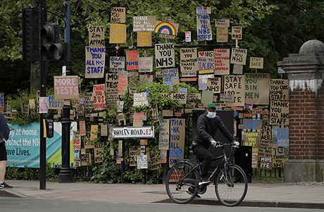 Signs supporting the National Health Service have been displayed by an artist in east London. (Matt Dunham / AP)