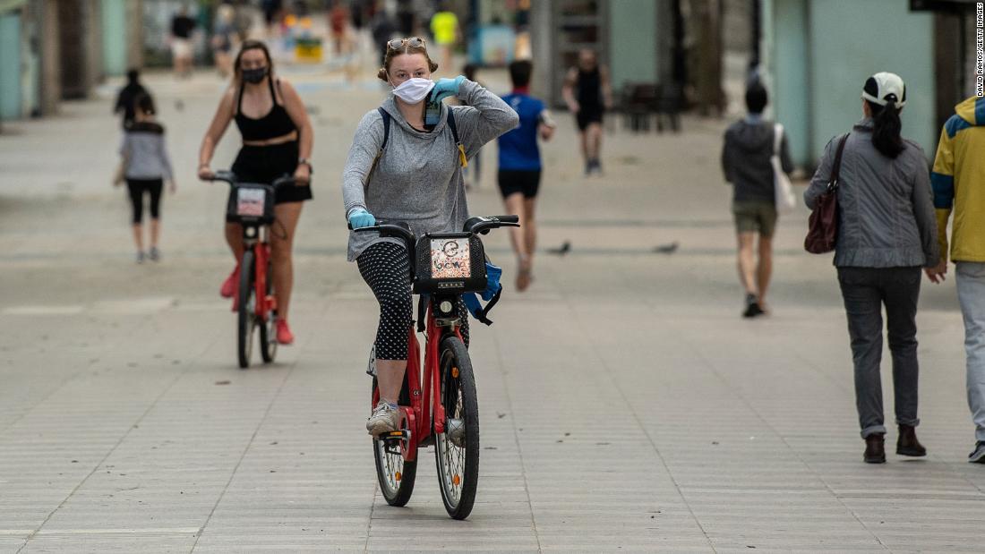 A woman rides a city bike on La Ramblas on May 2 in Barcelona, Spain as the country eased its Covid-19 lockdown measures.x