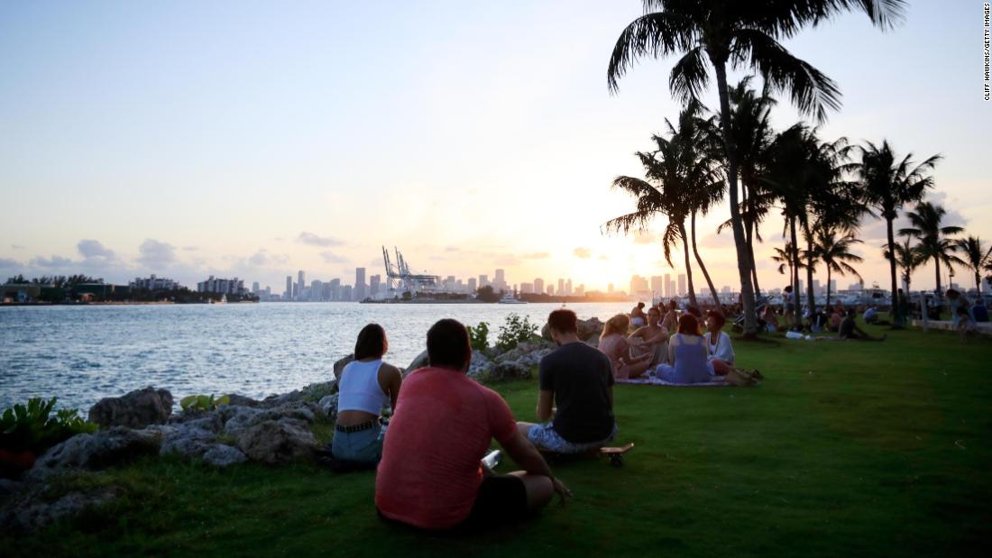 People gather for sunset in South Pointe Park on April 29, 2020 in Miami Beach, Florida.