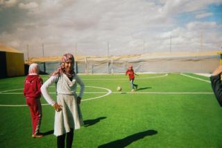 Girls train on a football pitch