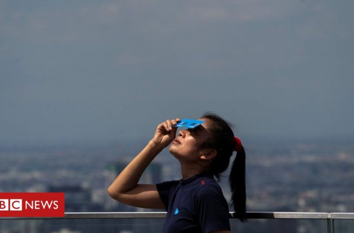 In pictures: Rare solar eclipse darkens Asia on the summer solstice