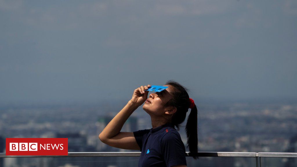 In pictures: Rare solar eclipse darkens Asia on the summer solstice