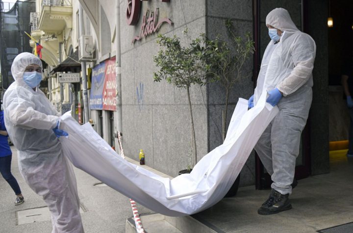 Forensic worker carry a body from a hotel downtown Bucharest, Romania, Friday, June 19, 2020. Gholamreza Mansouri, a former judge from Iran sought by his country to face corruption charges has died in unusual circumstances, Romanian media reported. Romanian police said only that a man had fallen from a high floor at a hotel in Bucharest, the Romanian capital, and was found dead. (AP Photo/Andreea Alexandru)