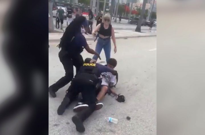 Miami protesters smashing cop car with skateboards: video