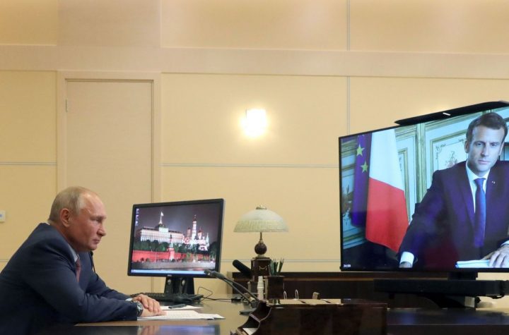 Russian President Vladimir Putin listens to French President Emmanuel Macron during a via video conference at the Novo-Ogaryovo residence outside Moscow, Russia, Friday, June 26, 2020. (Mikhail Klimentyev, Sputnik, Kremlin Pool Photo via AP)