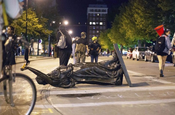 FILE - In this June 23, 2020 file photo, Wisconsin's "Forward" statue lies in the street on Capitol Square in Madison, Wis. Demonstrators who toppled statues this week honoring Hans Christian Heg, a Civil War abolitionist, and the state's "Forward" motto say they went after the sculptures because they wanted to shatter a false narrative that the state and the city support Black people and have achieved racial equity. (Emily Hamer/Wisconsin State Journal via AP File)