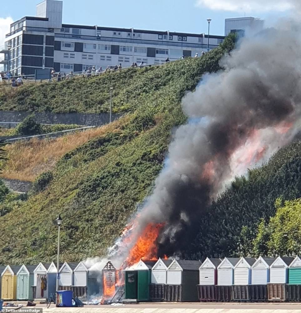 Unconfirmed reports suggest the fire was sparked by one of the burning beach huts before quickly engulfing 100sqm of heath