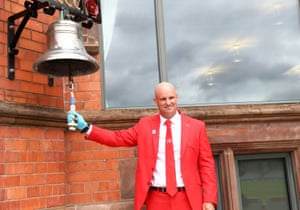 Andrew Strauss rings a bell to signify the start of play.