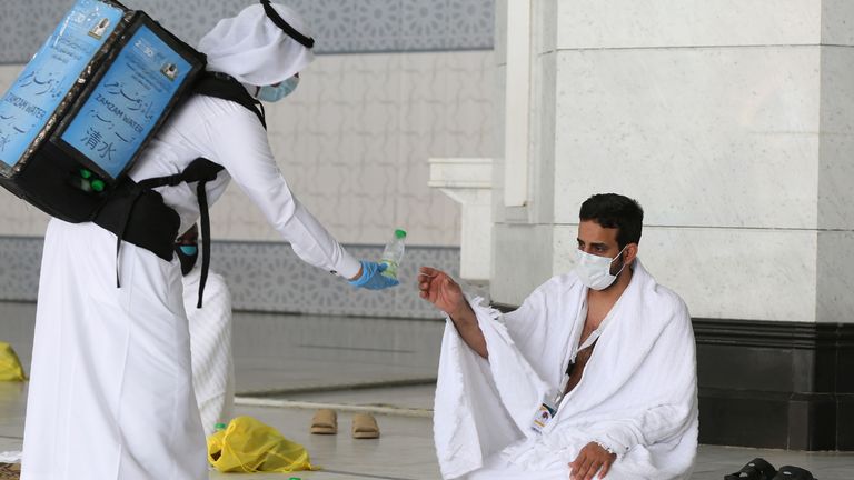 A pilgrim receives water at the Grand Mosque complex in Mecca