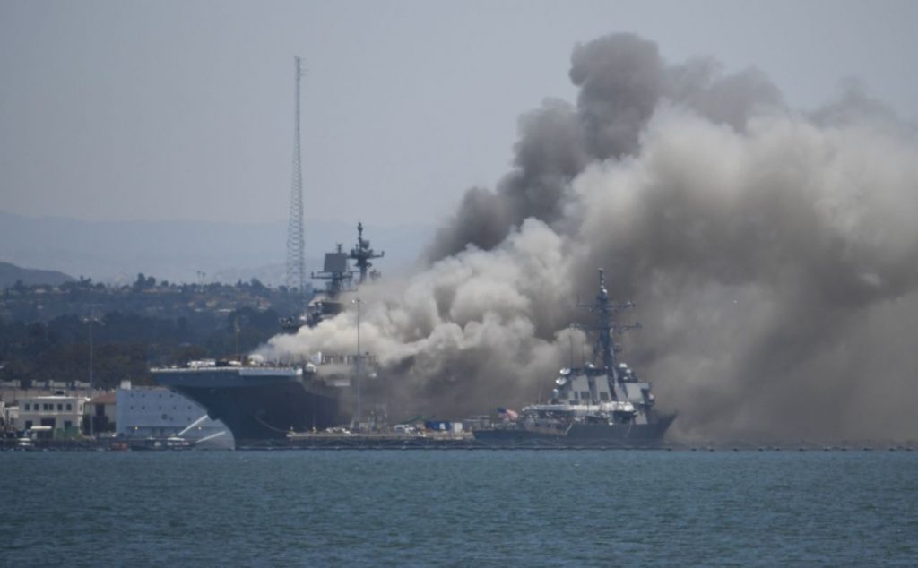 Smoke rises from the USS Bonhomme Richard at Naval Base San Diego Sunday, July 12, 2020, in San Diego after an explosion and fire Sunday on board the ship at Naval Base San Diego. (AP Photo/Denis Poroy)