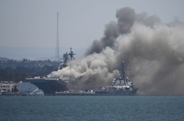 Smoke rises from the USS Bonhomme Richard at Naval Base San Diego Sunday, July 12, 2020, in San Diego after an explosion and fire Sunday on board the ship at Naval Base San Diego. (AP Photo/Denis Poroy)