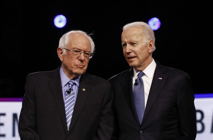 FILE - In this Feb. 25, 2020 file photo, Democratic presidential candidates, Sen. Bernie Sanders, I-Vt., left, and former Vice President Joe Biden, talk before a Democratic presidential primary debate in Charleston, S.C. Political task forces Biden formed with Sanders to solidify support among the Democratic Party's progressive wing recommended Wednesday, July 8, that the former vice president embrace proposals to combat climate change and institutional racism while expanding health care coverage and rebuilding a coronavirus-ravaged economy. (AP Photo/Matt Rourke, File)