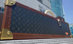 A giant mockup of a suitcase outside an official retail outlet of the French luxury goods maker Louis Vuitton in Shanghai, China.