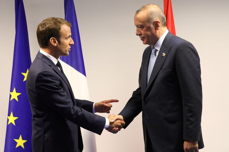 © Reuters. FILE PHOTO: France&apos;s President Emmanuel Macron shakes hands with Turkey&apos;s President Recep Tayyip Erdogan ahead of a bilateral meeting on the sidelines of a NATO summit in Brussels in 2018