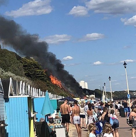 Emergency services have scrambled to the West Undercliff area, where a cordon has been erected and sun-bathers evacuated. The fire quickly spread from the burning beach huts and has blazed a path of destruction up 100sqm of heath where photos show it is perilously close to the cliff-top hotel and other homes.