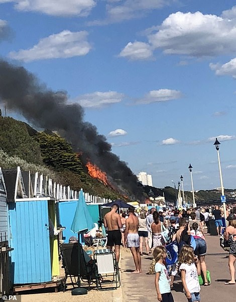 Emergency services have scrambled to the West Undercliff area, where a cordon has been erected and sun-bathers evacuated. The fire quickly spread from the burning beach huts and has blazed a path of destruction up 100sqm of heath where photos show it is perilously close to the cliff-top hotel and other homes.