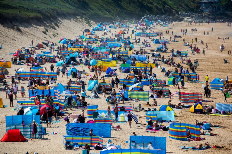 Tourists flock to the Fistral beach in Cornwall, as the UK enjoys a hot weather. 31st July 2020