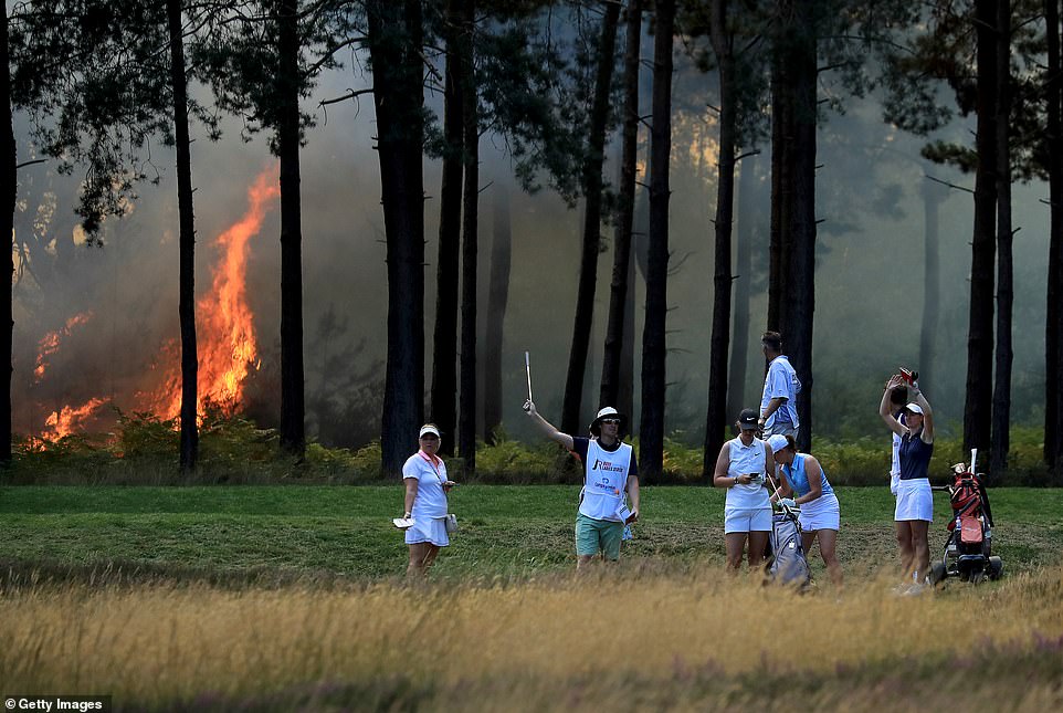 The fire stops play as the group of Cara Gainer, Sophie Powell and Gabriella Cowley wait to play off during day three of The Rose Ladies Series on The West Course at Wentworth Golf Club