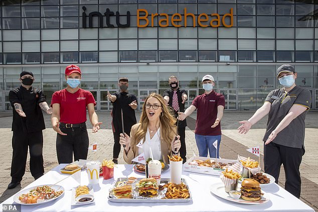 Madison Dock (centre) from Johnstone, Renfrewshire, sits outside intu Braehead in Glasgow where diners will be able to enjoy half-price meals, at participating restaurants from today