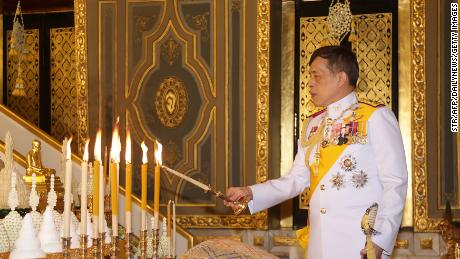 King Waziralongkorn of Thailand lights candles during a Buddhist ceremony on October 10, 2020 at Wat Ratchabofit, Bangkok, during the 2020 Kathina Festival.