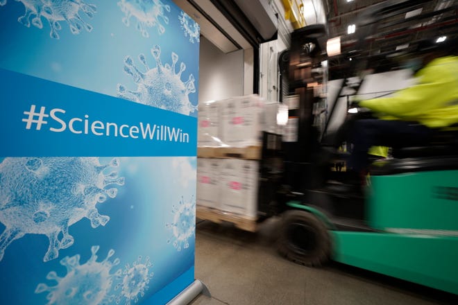 Boxes containing the Pfizer-BioMTech COVID-19 vaccine were loaded into a truck on Sunday for shipping at the Pfizer Global Supply manufacturing plant in Portage, Michigan.