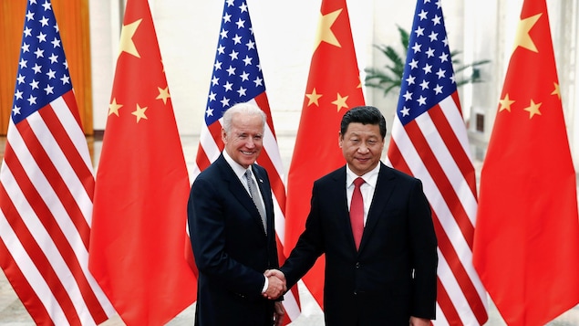 Joe Biden et Xi Jinping se serrent la main.