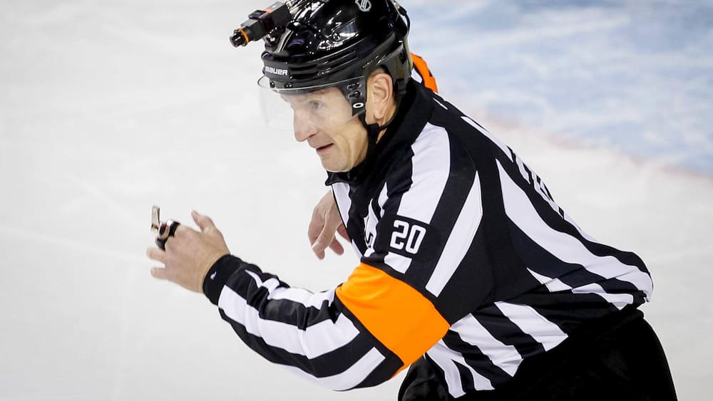 NHL Referee Tim Peel shows the door