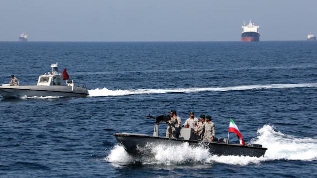 The U.S. Navy attempts to disperse Iranian ships in the Strait of Hormuz