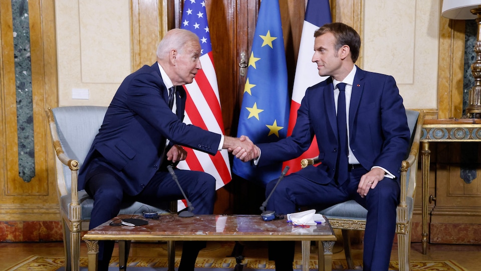 Joe Biden and Emmanuel Macron both sat down and shook hands,
