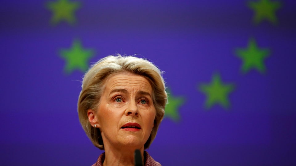 Ursula van der Leyen in front of the European Union flag.