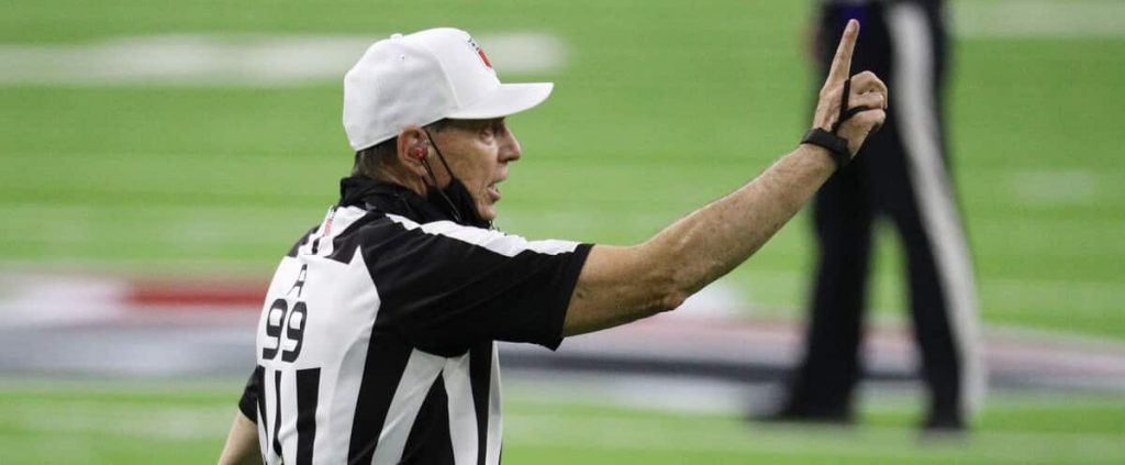 NFL referee in the middle of a dispute
