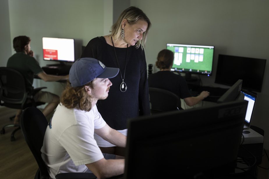 Marion Duchesne, founder and CEO of Mediaclip, with Maxime Therrien-Arel and other programmers in the basement of the company's chalet equipped for teleworking. 