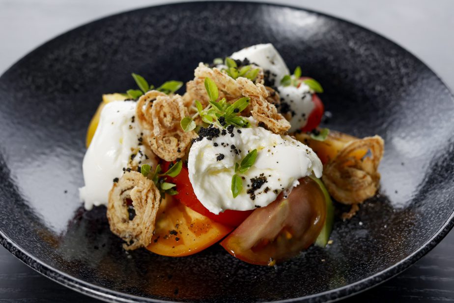 Buffalo mozzarella from Saint-Charlessur-Richelieu, chambered tomatoes, 5-year-old balsamic, floral extra-virgin olive oil, finely grated Parmesan, roasted shallot and micro basil