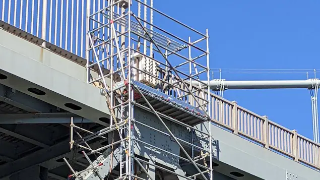 Steel structure attached to the bridge structure.