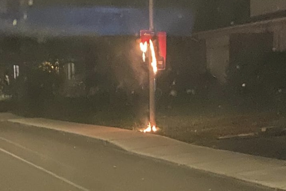 An election sign is burning in Dollard-des-Ormeaux