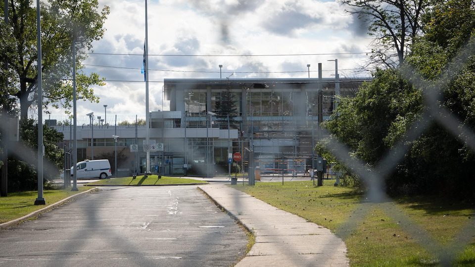 A detention center behind a metal fence