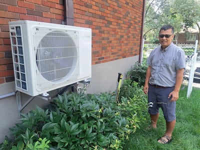 Trung Nguyen shows his five 2m by 1m solar panels on the sloping roof of his house in Saint-Laurent borough.