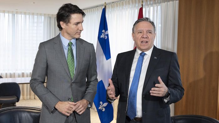 Justin Trudeau and Francois Legault, standing side by side at an official meeting.